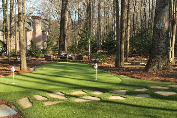 Metro New York backyard putting green with flags and trees